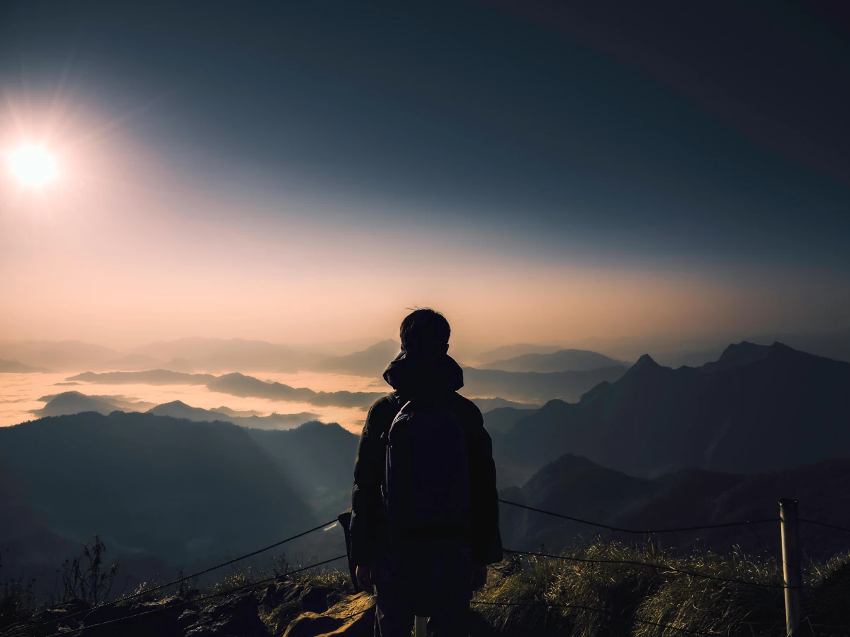 Man looking at mountain.
